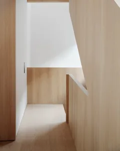 A modern interior design featuring wooden walls and floors, with a minimalist aesthetic.