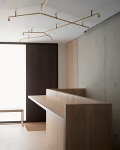 A modern office space featuring a wooden desk and minimalist design.
