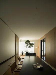 Minimalist living room with a sleek, modern design featuring bamboo elements and ample natural light.
