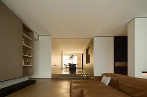 A minimalist living room with wooden shelves, furniture, and flooring.