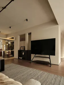 A minimalist living room featuring wooden furniture.