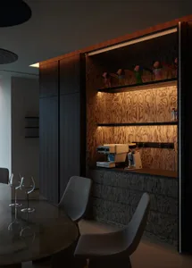 Modern dining room featuring wood-paneled walls and a sleek table with chairs.