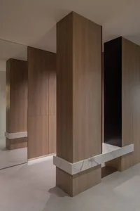 Modern industrial interior with wooden paneling and marble counter