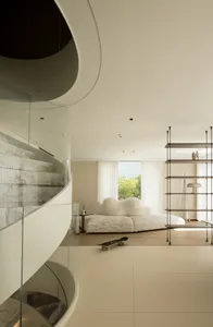 Modern interior design featuring concrete walls, marble accents, and hardwood flooring in a living space.