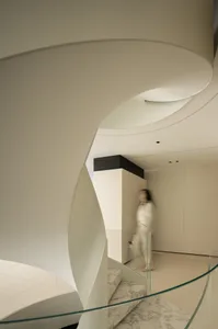 A modern interior space featuring glass and marble elements.