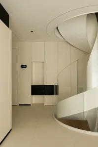 Modern interior design featuring a glass spiral staircase.