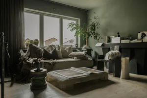 A modern living room featuring concrete furniture and wooden accents