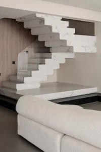 Modern interior design featuring a contemporary marble staircase in a living room setting.