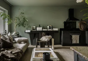 A modern living room with wooden furniture, greenery, and a cozy atmosphere.