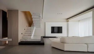 A modern living room featuring marble-clad furniture and minimalist decor.