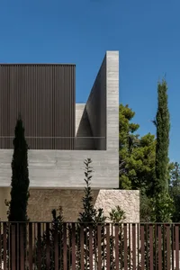 A modern building with a concrete exterior features clean lines and geometric shapes.