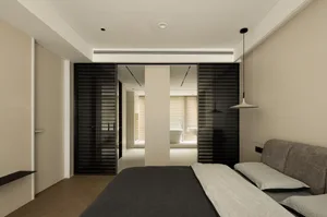 A minimalist bedroom with a bed, a sofa, and black blinds in a neutral-colored room