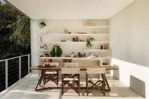A modern dining room with wooden furniture and white decor elements.