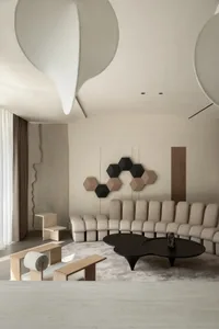 Contemporary living room featuring a neutral-toned color palette with modern furniture, clean lines, and geometric patterns.