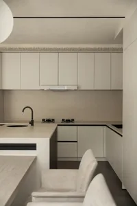 Modern minimalist kitchen featuring concrete countertops and cabinets
