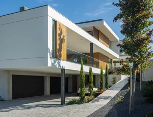 Modern architecture with concrete exterior, clean lines, and large windows.