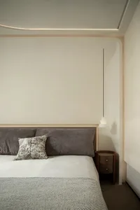 Minimalist bedroom with a modern design featuring a textured cotton fabric bedspread and pillow.