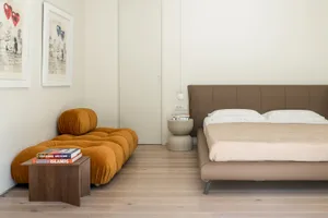 A modern bedroom featuring a leather bed.