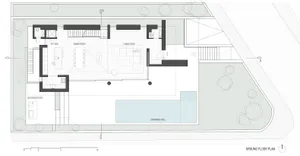 Modern living space with a concrete floor plan, featuring a kitchen, dining room, living room, and outdoor kitchen.