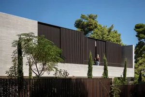 Modern residential building with concrete and metal exterior.