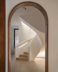 A modern white staircase with wooden elements in a contemporary interior setting.