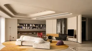 A minimalist living room with a modern sofa, bookshelf, and television.