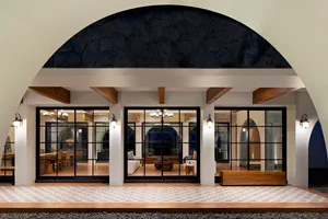 A modern entrance lobby featuring glass and wooden elements.