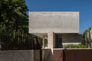A modern house with a minimalist design featuring a concrete exterior.