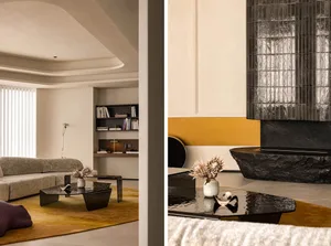 A modern living room featuring concrete and glass elements.