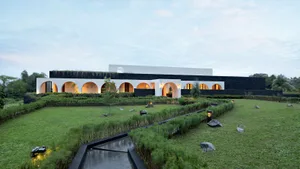 A contemporary residential building with modern concrete and glass design elements.
