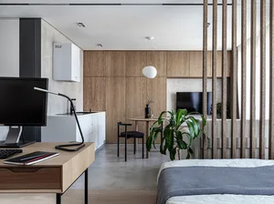 A modern residential space featuring minimalist design with wood, concrete, and metal materials.