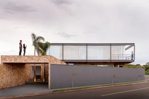 A modern building entrance with concrete walls and glass panels.