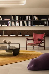 A modern living room with wood furniture and leather accents