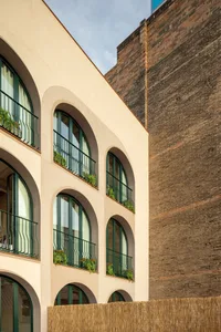 Modern building exterior with brick, metal, and concrete materials.