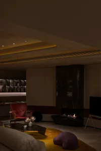 A modern living room featuring sleek, metallic furniture and a cozy fireplace.