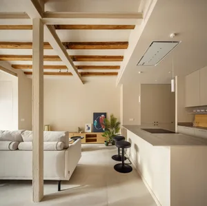 A modern residential kitchen featuring white concrete cabinets and minimalist design.