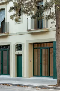 Modern residential facade with metal gate and plaster finish