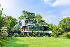 Modern residential home featuring extensive use of glass windows and doors.