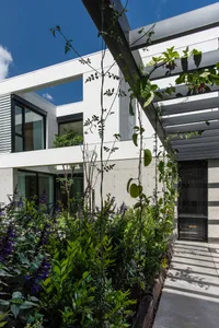 A modern house exterior with concrete and glass materials.