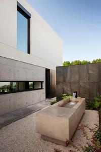 A minimalist modern house features a concrete exterior.