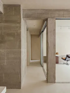 Modern minimalist office space with concrete walls and open space layout.
