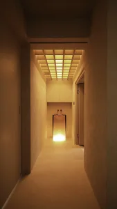 Modern concrete bathroom with a minimalist design and illuminated sink.