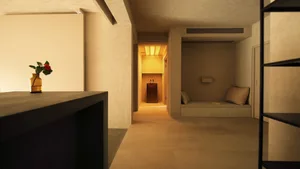 A modern living space with minimalist design features, concrete floor and walls.