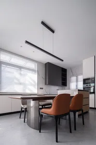 Contemporary kitchen interior with white marble countertops, stainless steel appliances, and minimalist design.