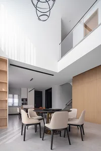 Modern minimalist dining room featuring dark wooded table and chairs