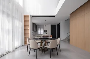 Modern minimalist dining room with wooden furniture and large windows.