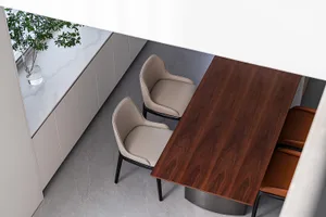 Modern dining room featuring wooden furniture and minimalist design.