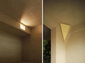 Modern industrial-style lighting fixture mounted on a concrete wall.