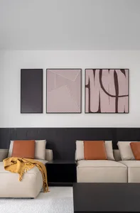 A modern living room featuring textured wall materials with contemporary art installations.