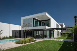 Modern residential home with concrete exterior, featuring clean lines and large windows.